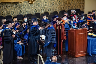 graduates in gowns on stage